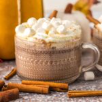 A glass of pumpkin hot chocolate made in the slow cooker.