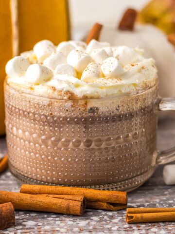 A glass of pumpkin hot chocolate made in the slow cooker.