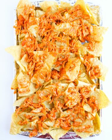 Buffalo shredded chicken on top of corn tortillas.