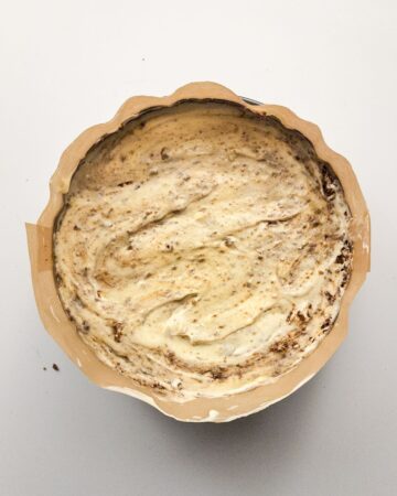 A cinnamon swirl cheesecake in a springform pan ready for the oven.