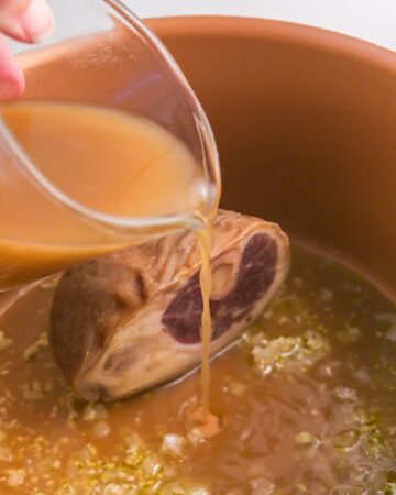 Ham hocks and onions with water being added to make collard greens.