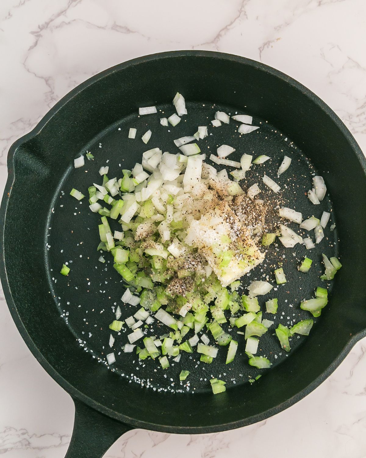 Saute pan with onions and celery to make stuffing with cranberries and walnuts. 