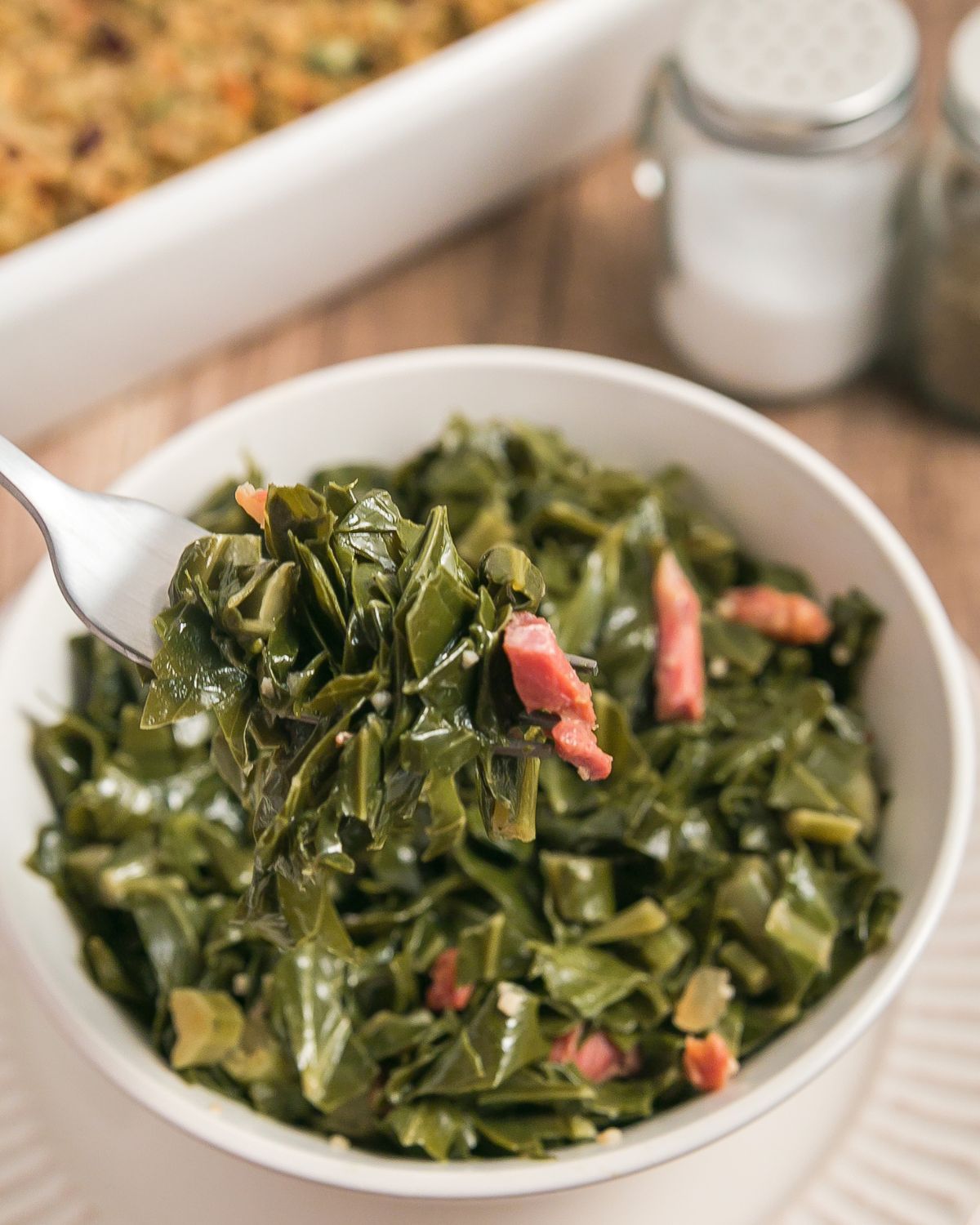 A bowl of collard greens made with ham hock.