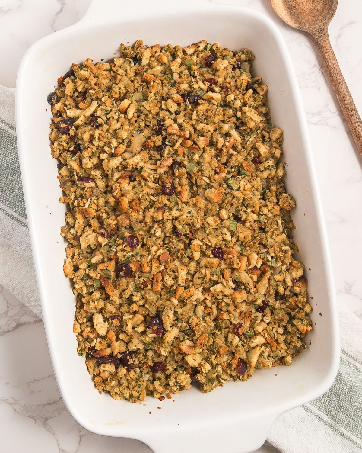 A casserole dish with oven baked stove top stuffing with cranberries and walnuts.