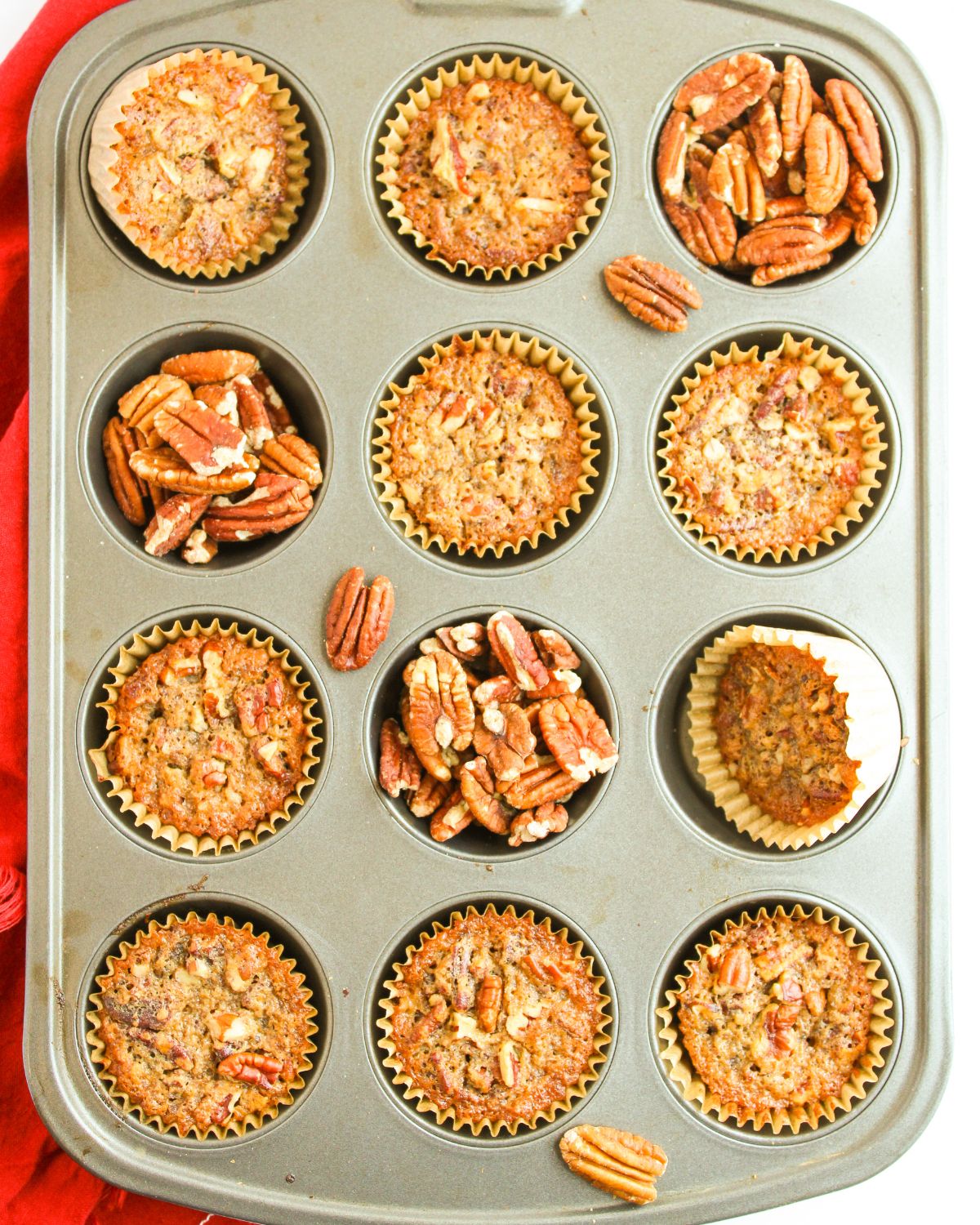 A cupcake pan with pecan pie muffins in the tin.
