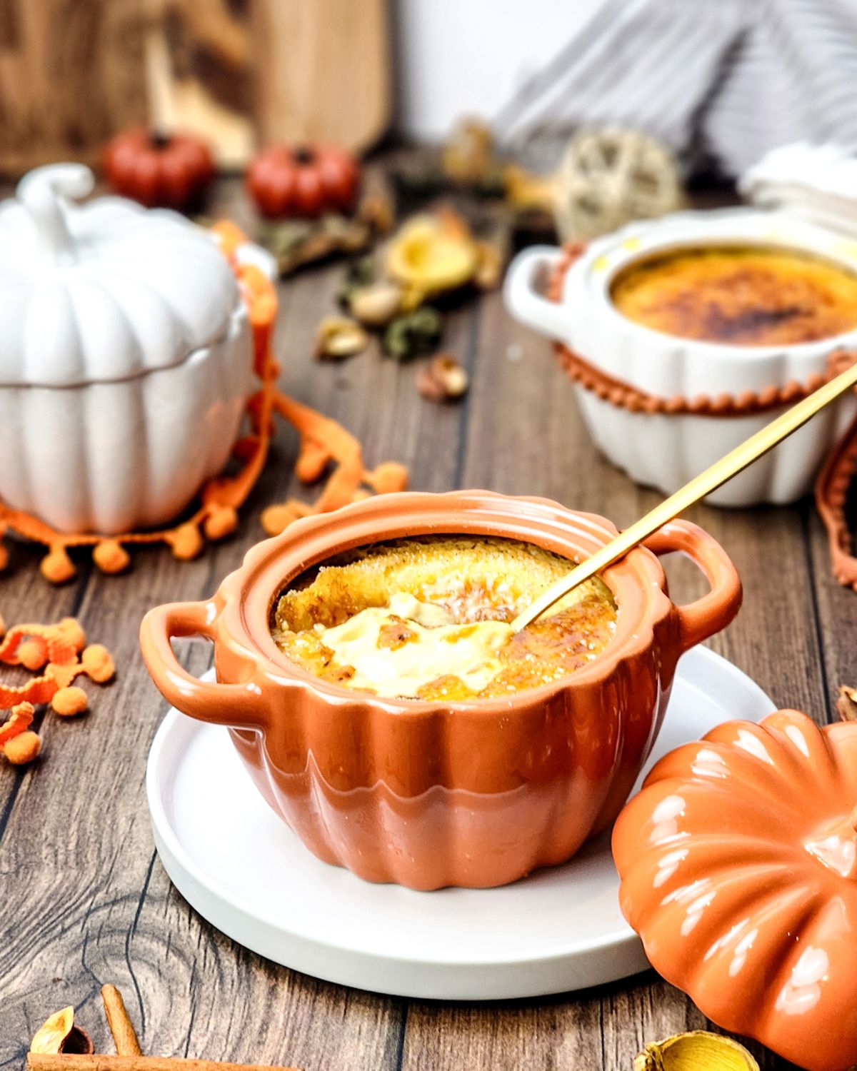 Pumpkin Creme Brulee in a ramkekin on a wooden table.