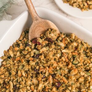 Stuffing made with stove top stuffing mix, walnuts, and cranberries in a casserole dish.