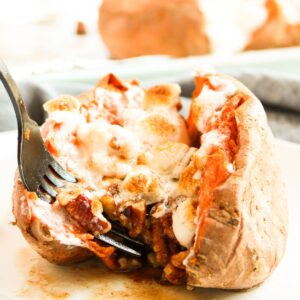 Stuffed sweet potatoes with pecans, butter, brown sugar, and marshmallows.