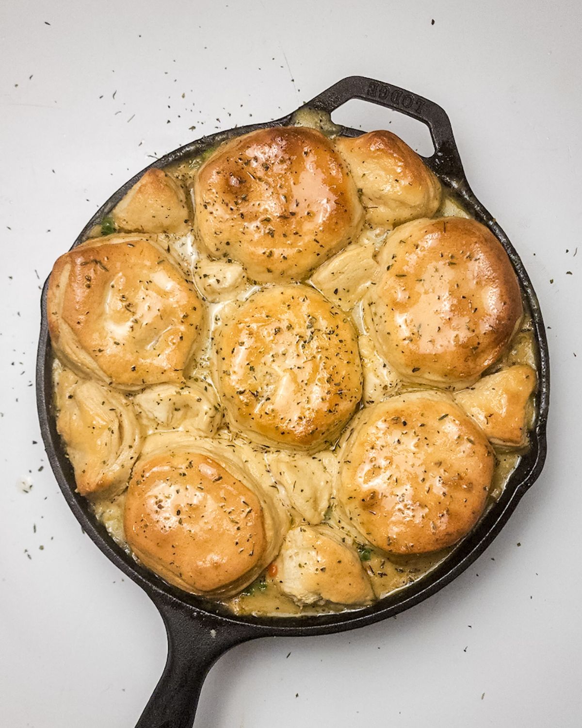 Biscuit topped chicken pot pie in a cast iron skillet.