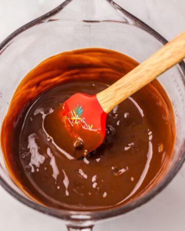 A glass bowl with butter and melted chocolate.