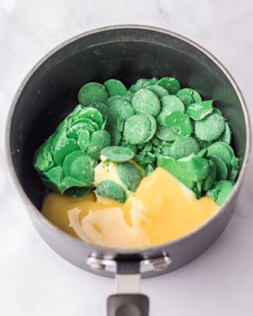 A pan with green melts and butter to make a ganache for brownies.