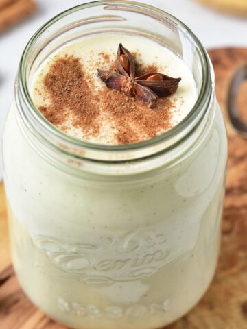 Easy homemade eggnog in a mason jar with nutmeg and star anise.