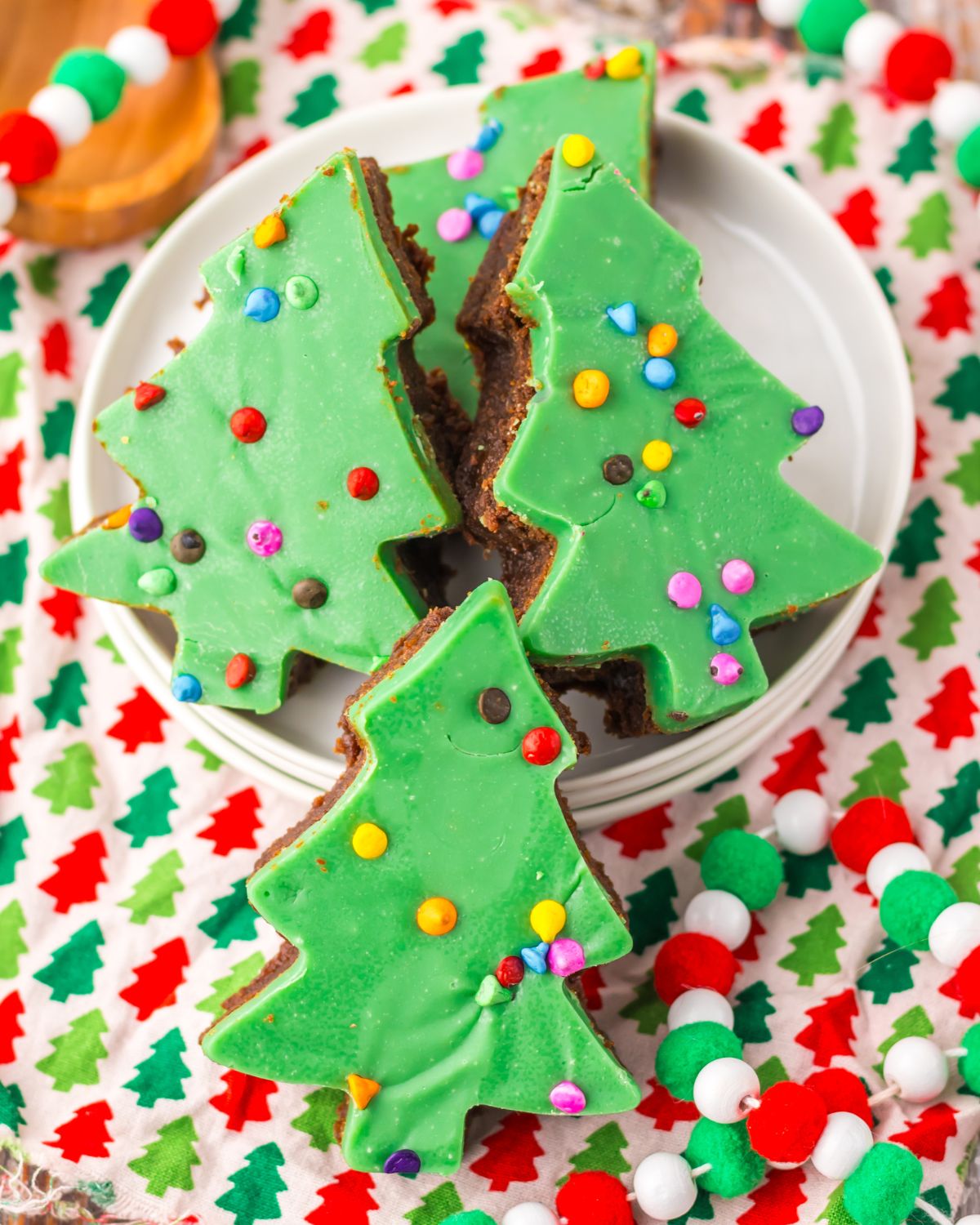 Cosmic Brownies Christmas trees with a green ganache on a plat.
