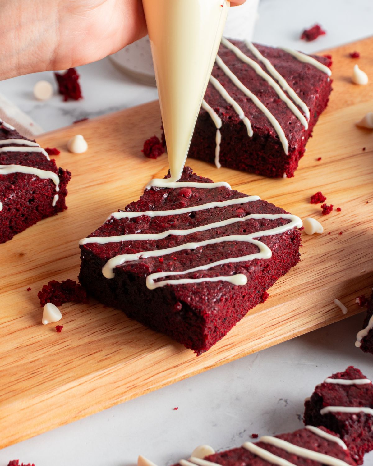 Red velvet brownies with a white chocolate drizzle. 