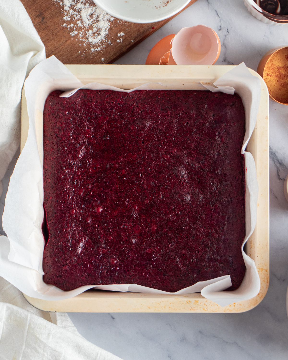 A square baking pan with red velevet brownies in the pan.