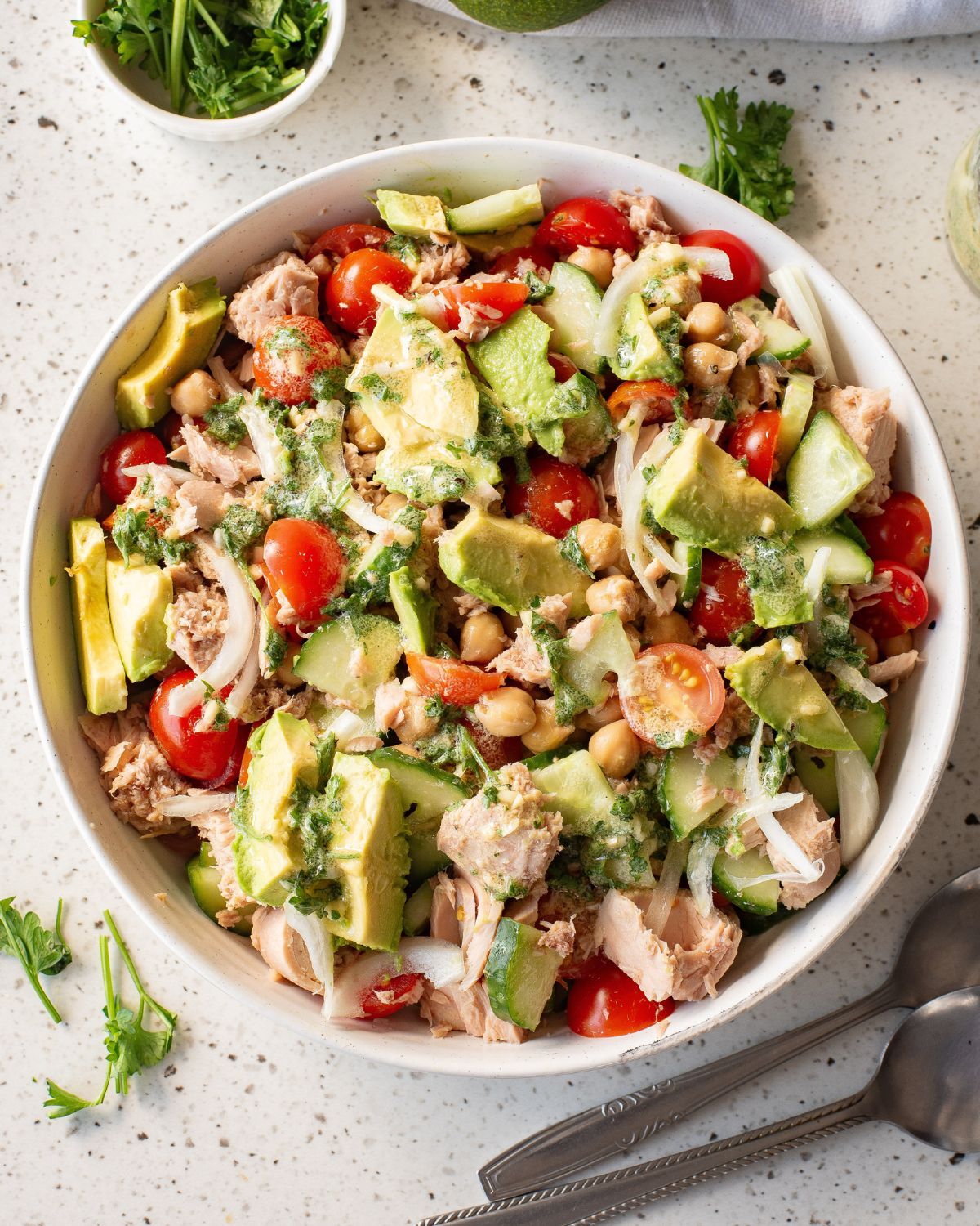 Tuna salad with avocados and chickpeas in a bowl.