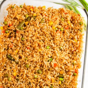 Baked fried rice in a pan with vegetables.