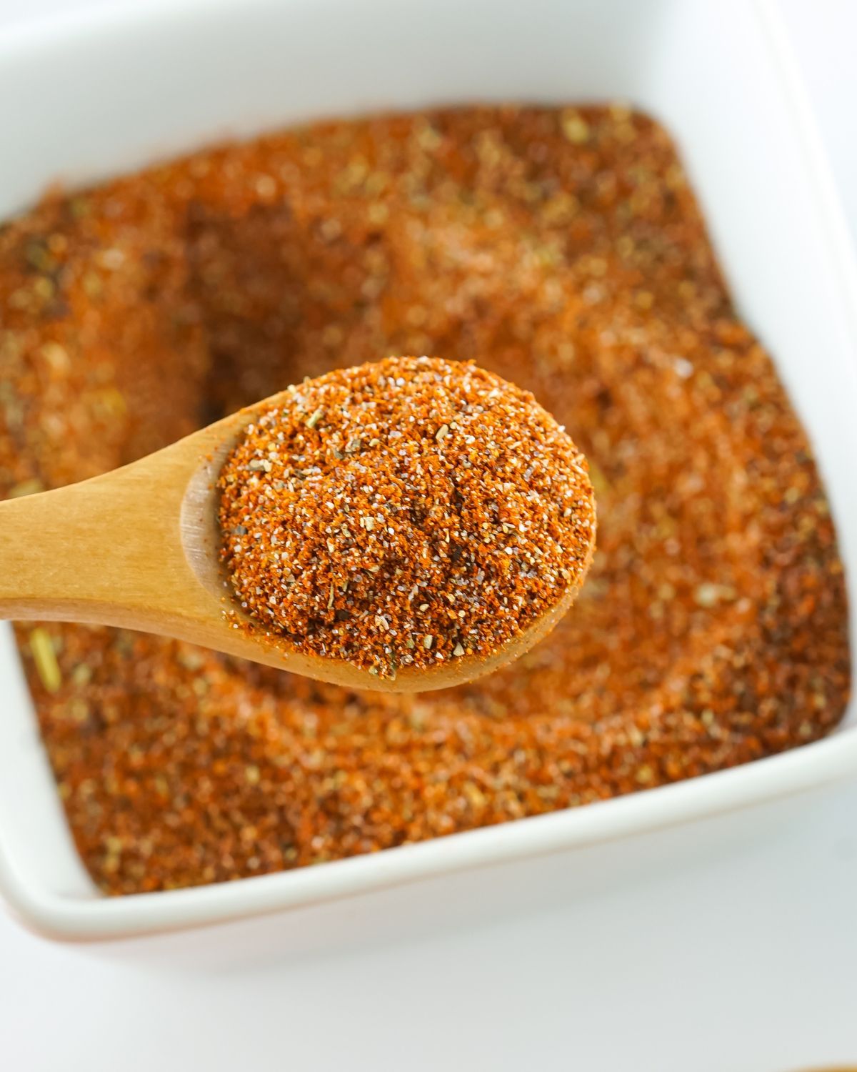 A spoon with blackened seasoning.