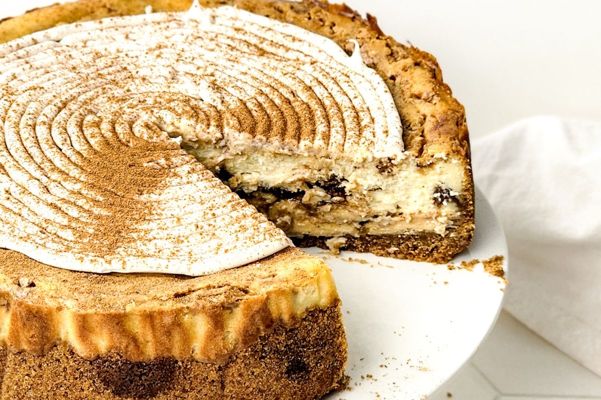Cinnamon Roll Cheesecake recipe with a cinnamon swirl and cinnamon roll topping.