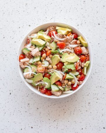 Ingredients to make avocado chickpea tuna salad in a bowl.