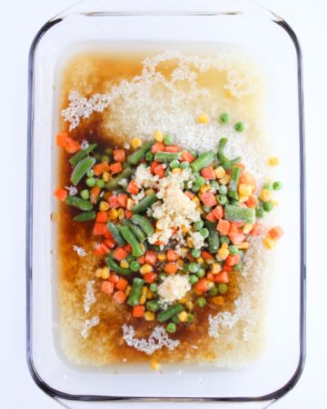 Ingredients to make baked fried rice in a casserole pan.
