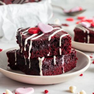 Red velvet brownies sliced on a plate.