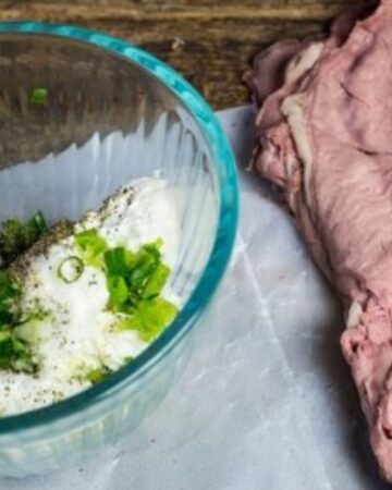 Cream cheese mixture in a bowl to make roast beef wraps.