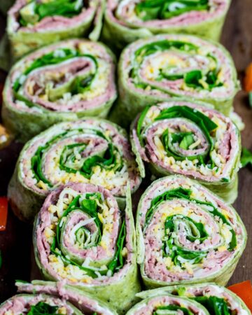 A plate of tortilla roll ups made with roast beef.