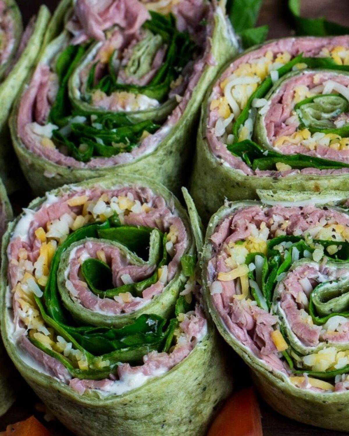 Spinach wraps with roast beef, spinach, and cheddar cheese.