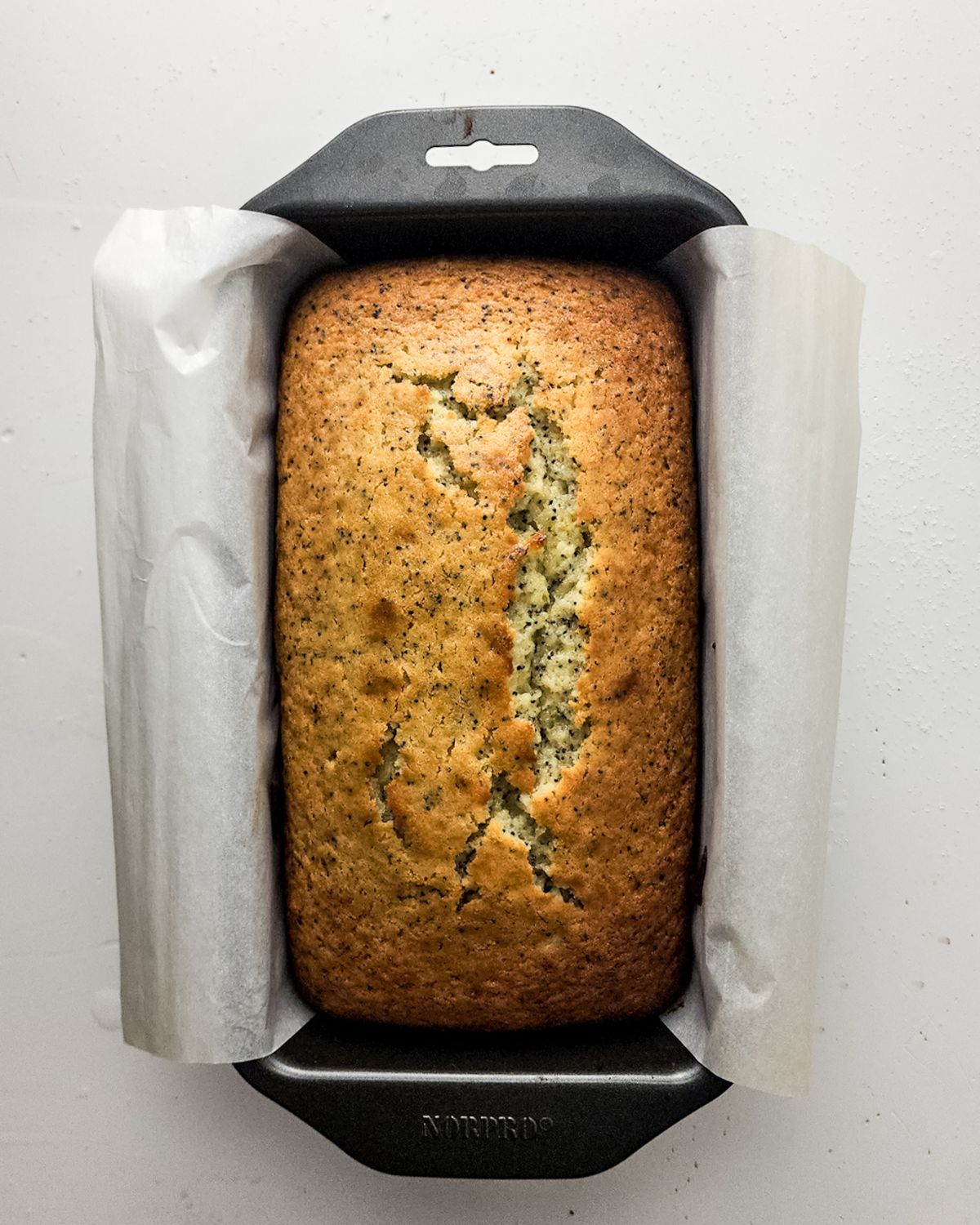 A lemon poppy seed loaf in the pan. 