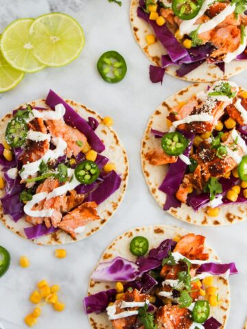 An overhead of blackened salmon street tacos on a plate.