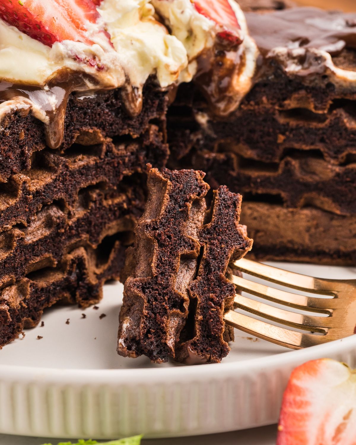Sliced chocolate waffles on a fork.