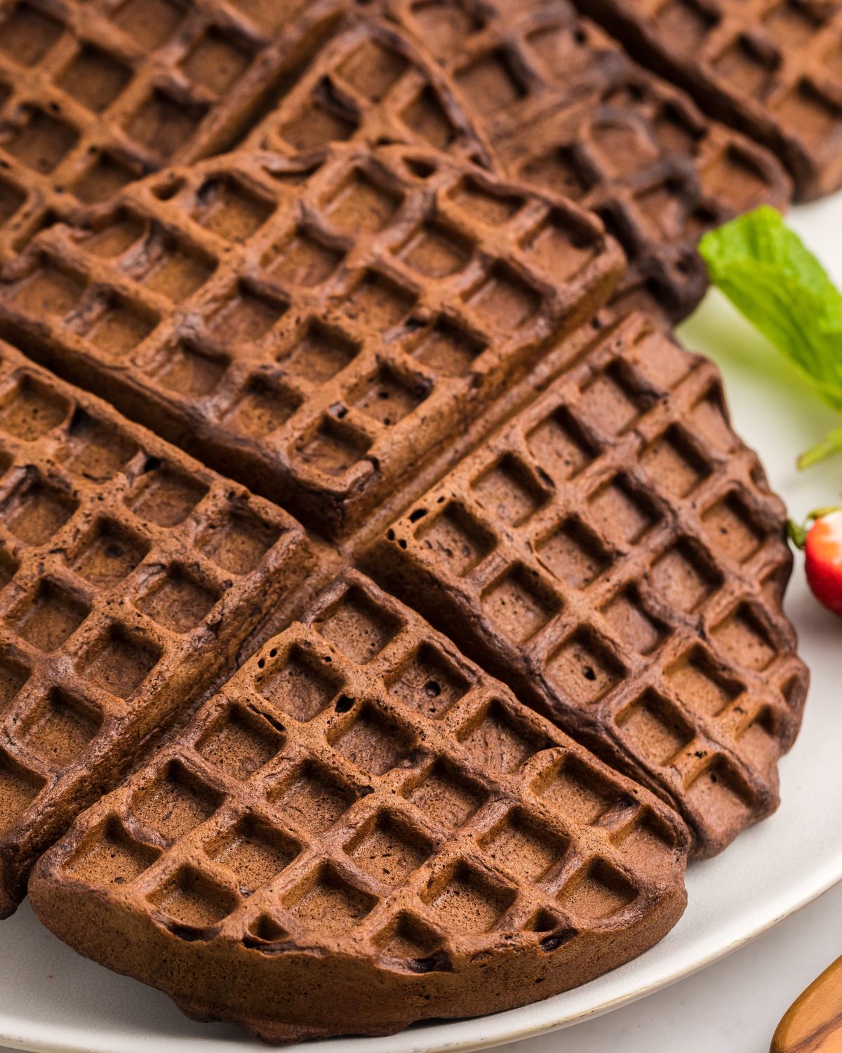 Homemade chocolate waffles on a plate.