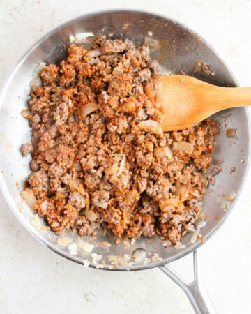 Ground beef that is browned with onions and taco seasoning to make baked tacos.