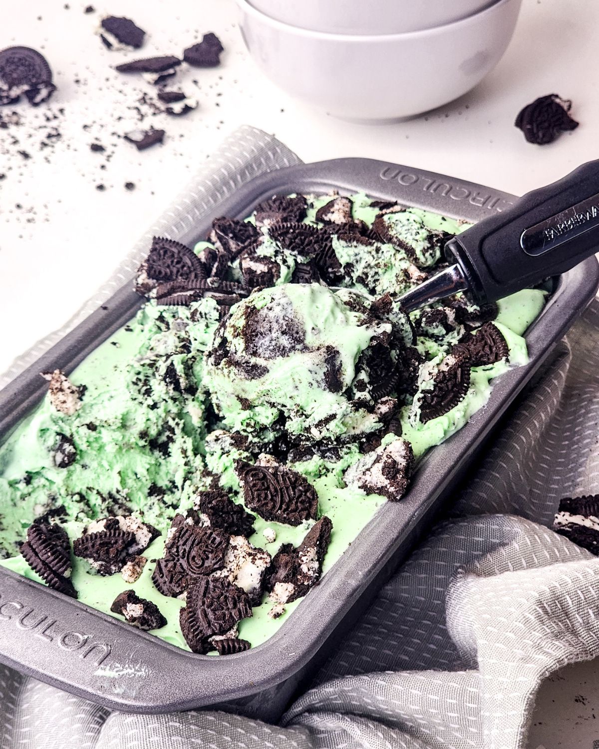 An ice cream pan with no churn mint ice cream with chopped oreos. 