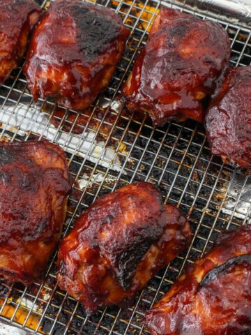 BBQ oven baked chicken thighs on a rack.