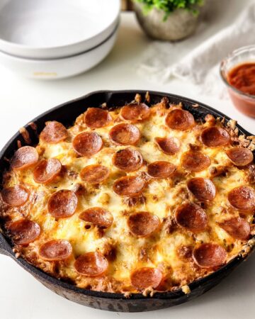 Pepperoni pizza pasta in a cast iron pan. 