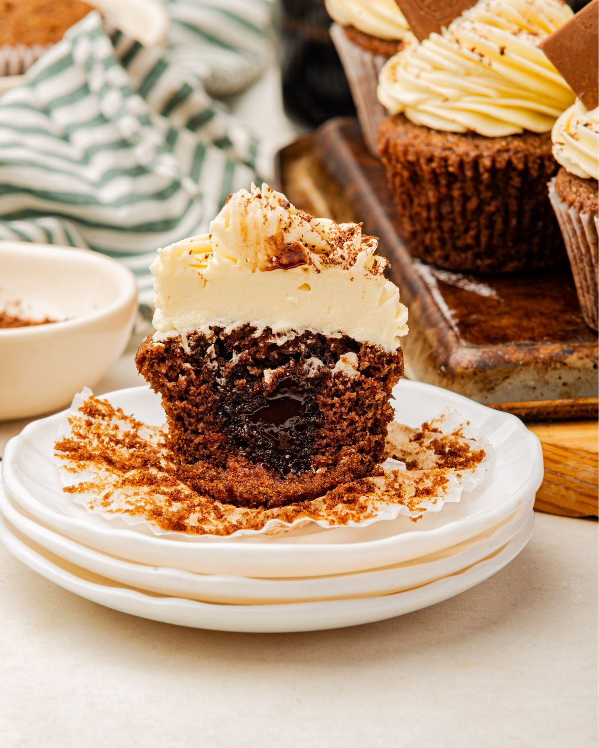 A slice of Baileys cupcakes with a chocolate syrup center topped with a Bailey's buttercream frosting. 
