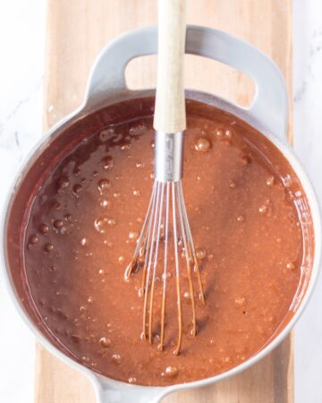 Mixing butter mixture to dry mixture for a chocolate cake batter.