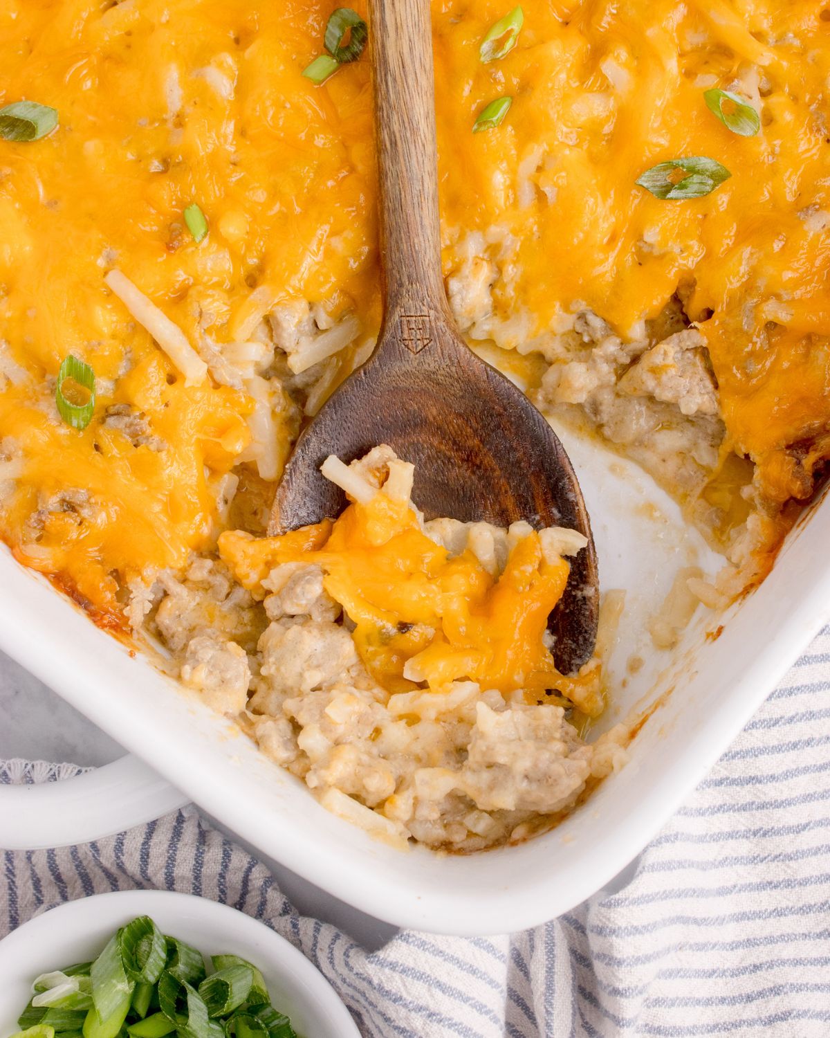 A scoop of hash brown casserole with ground beef.