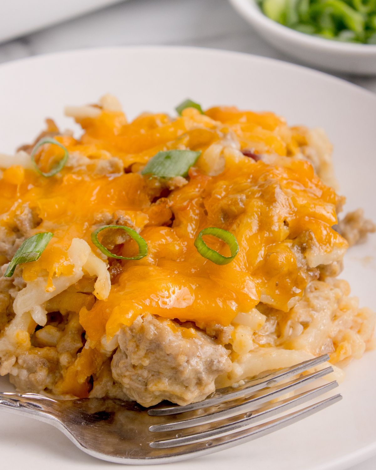 A plate of hamburger hash brown casserole on a plate. 