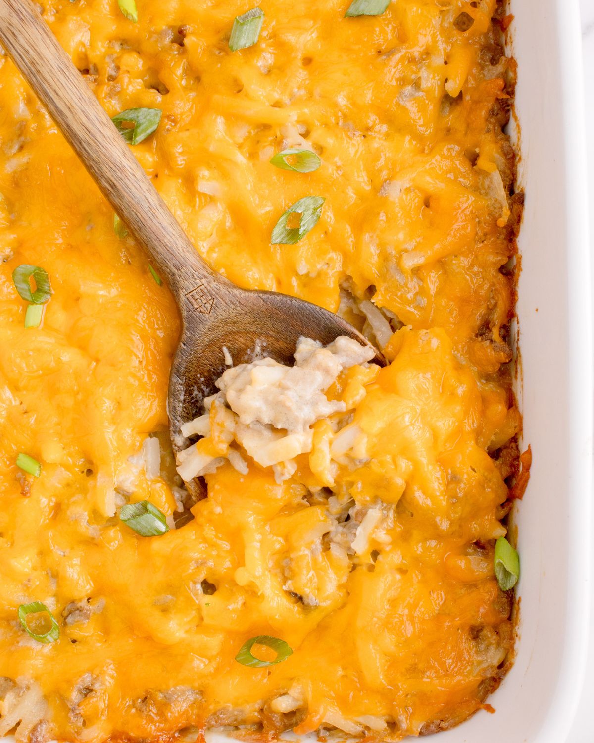 A casserole with ground beef and hash browns topped with cheese.