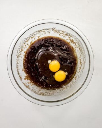 A glass bowl with butter, sugar, and eggs to make a smores oreo cookie. 
