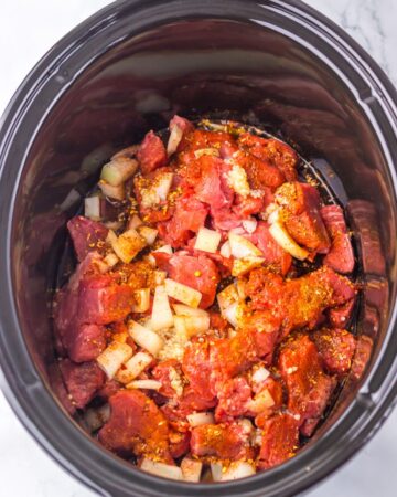 A slow cooker with ingredients to make birra sliders.