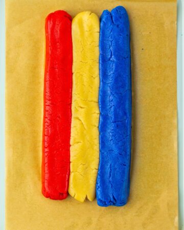 Three logs of cookies, one red, one white, and one blue to make patriotic cookies.