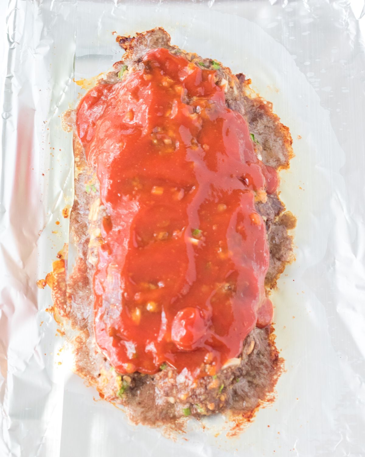 A copycat cracker barrel meatloaf topped with a ketchup based topping.