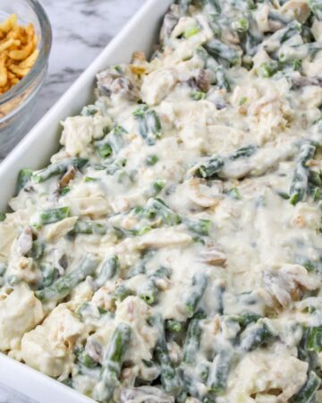 A casserole dish with chicken and green beans in a mushroom sauce.