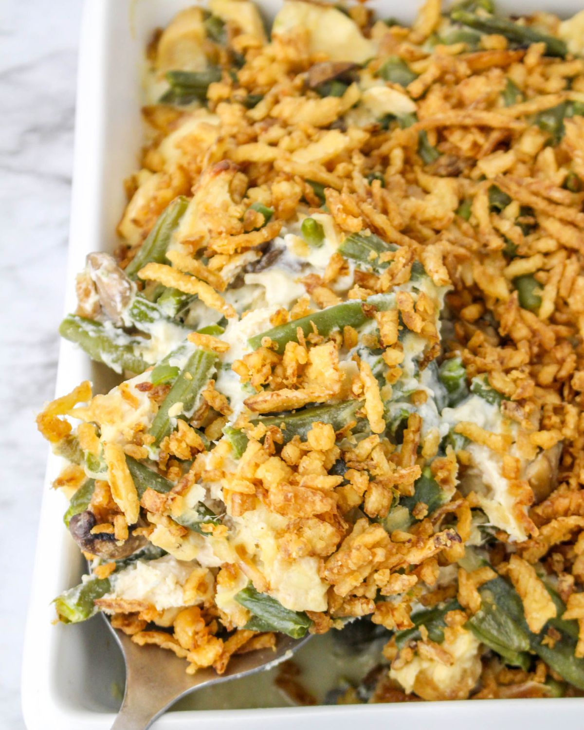A green bean casserole with chicken in a mushroom sauce.