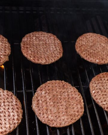 Frozen hamburger patties on a grill to make frozen hamburgers.