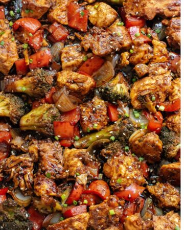 Soy Ginger Chicken and vegetables on a sheet pan topped with sesame seeds